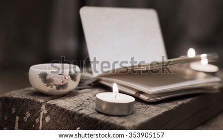 Artwork in vintage style, china tea, notebook, candles