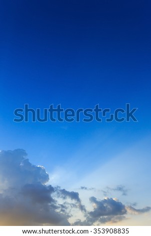 beautiful light of sunbeams through clouds, light rays on dramatic sunset sky background