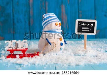Spring wooden sign with snowman, sled and word 2016. New year travel concept.