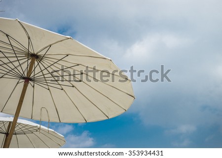 Big white umbrellas and blue background.
