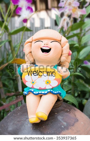 Welcome happy woman clay doll in the garden.