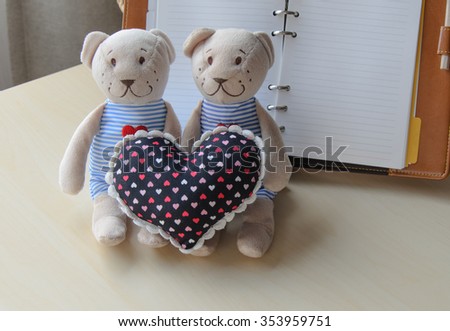 two teddy Bear and Heart on desk with diary  concept valentine 
