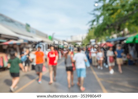 Abstract blur tourist shopping in Chatuchak weekend market outdoor in sunny day Bangkok Thailand background