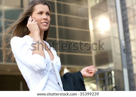 Young attractive businesswoman walking along the street