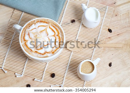 Capucino art coffee on wooden texture table