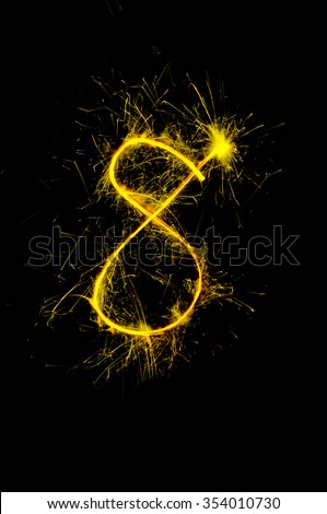 "8" number drawn with bengali sparkles isolated on black backgroundnumber from sparkler on black background