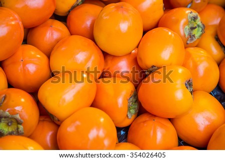 Orange persimmon kaki fruits freshly Royalty-Free Stock Photo #354026405