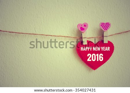 Red heart with 2016 number decoration hanging over wall grunge background, Happy new year concept.