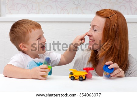 mother playing with her son Royalty-Free Stock Photo #354063077