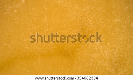 Golden bubbly texture of honey. Closeup