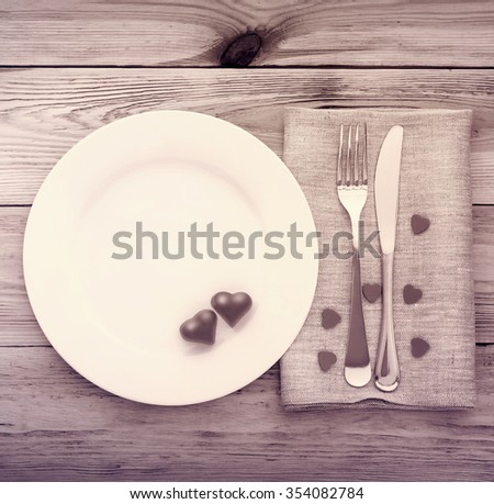 Valentines day set with silverware. Valentine day love beautiful. Romantic dinner, tableware and hearts on wooden background.Top view. 