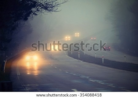 Cars in the fog Royalty-Free Stock Photo #354088418