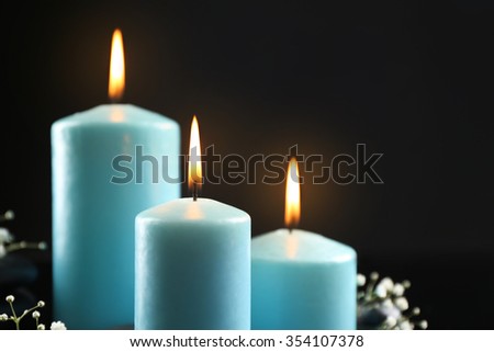 Blue burning candles closeup
