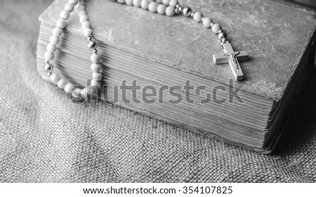 vintage rosary beads on old books,horizontal photo