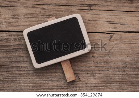 Small black chalkboard on wood background