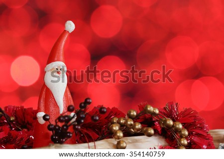 santa claus christmas decoration with red bokeh background