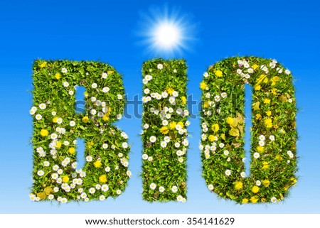 BIO - Text with grass texture on blue sky and sun