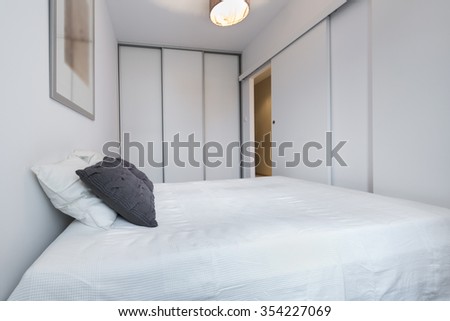Stylish white bedroom in small apartment, scandinavian style