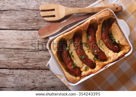 English food: toad in the hole into a baking dish on the table. Horizontal top view
