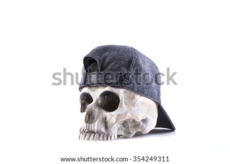 isolated human skull and cloth-cap on the white