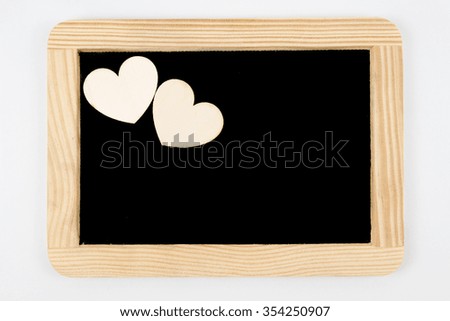 Vintage Chalkboard with wooden frame isolated on white, two craft heart shapes in upper left corner,  creativity and love concept