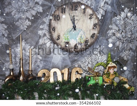New year number 2016 placed on fireplace next clock 