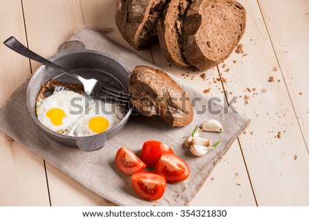 Fried eggs on wooden table