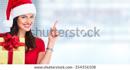 Happy Santa woman with Christmas gift over abstract background.