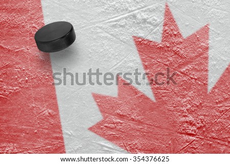 Hockey puck and the image of the Canadian flag. Concept