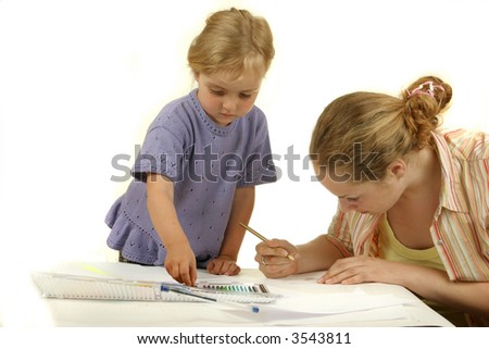 preschool girl painting with her mother