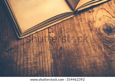 Old book wooden library desk, retro toned image, selective focus Royalty-Free Stock Photo #354462392