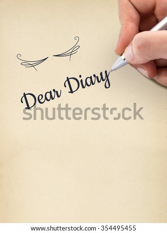 Hand writing "Dear Diary" on aged sheet of paper.