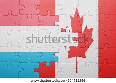 puzzle with the national flag of canada and luxembourg . concept