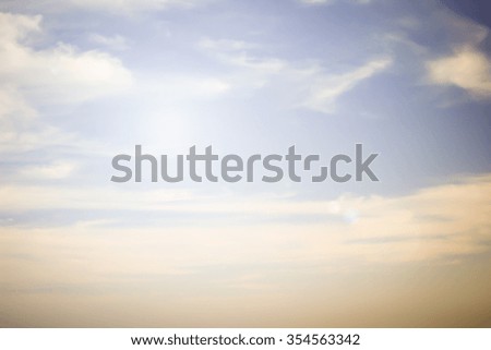 abstract blur sky background in vintage tone with sunshine flare lights