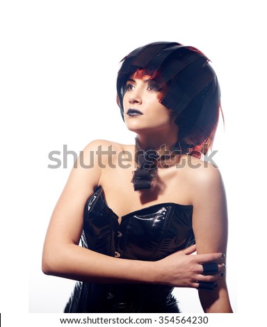 Beautiful stylish woman in leather corset and filmstrips hairstyle posing isolated on white background