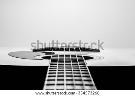 Guitar Strings, close up. Acoustic guitar. Black and white photography. Royalty-Free Stock Photo #354573260