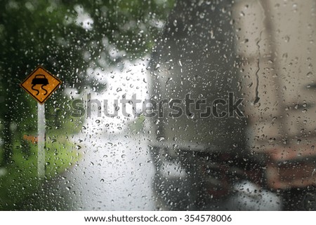 View through the wind shield of rainy day with traffic sign,Shallow depth of field composition.