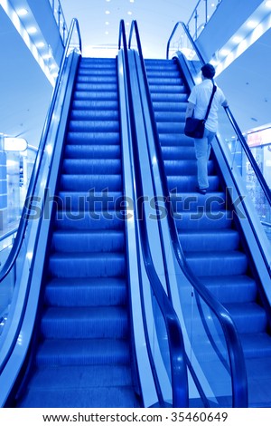 person on moving escalator in airport