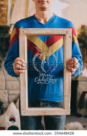 A man holding box with text Christmas glass