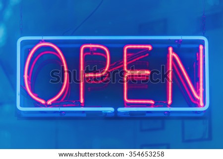 Open sign in blue and red neon colors, filters applied.