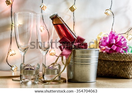 Cool Champagne and glass prepare for Celebration. Candle is lighting in a candlestick in Christmas and New year festival.