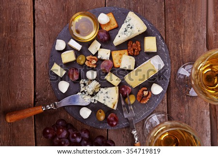 Top view of cheese for tasting on wooden table