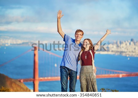Romantic loving couple having a date in San Francisco, California, USA. Golden gate bridge in the background