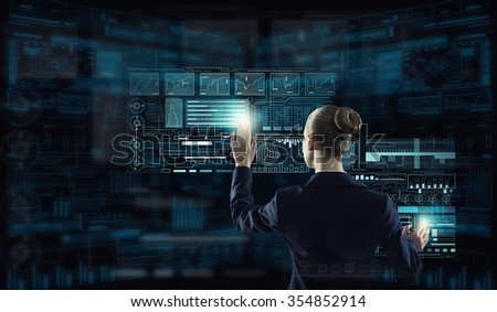 Rear view of businesswoman working with virtual panel interface