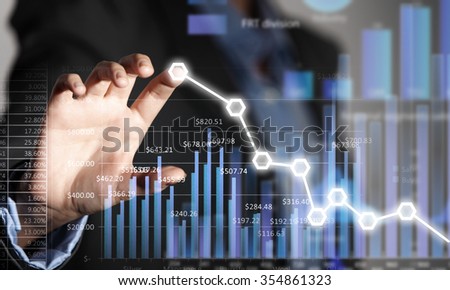 Close view of businesswoman touching screen with market infographs