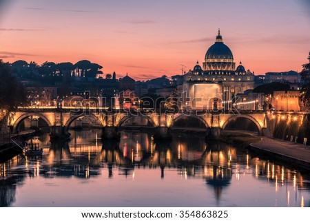 Rome, Italy: spectacular St. Peter's Basilica, Saint Angelo Bridge and Tiber River in the beautiful sunset of Mediterranean winter. Amazing picture representing the beauty of Italian capital city. 