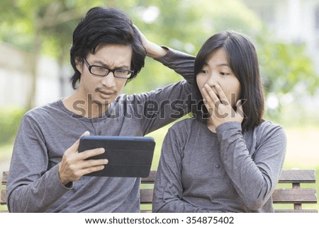 Couple Use Tablet at Park