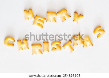 Merry Christmas text biscuits on white background