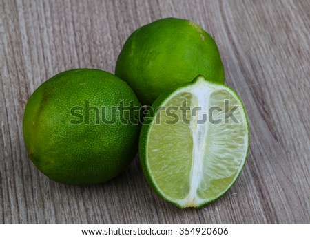 Tropical fruit - green sloced lime on the wood background