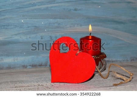 Valentine's day. A little red heart with a candle 